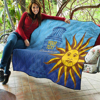 Blue quilt with custom text and golden sun face graphic, used as outdoor blanket