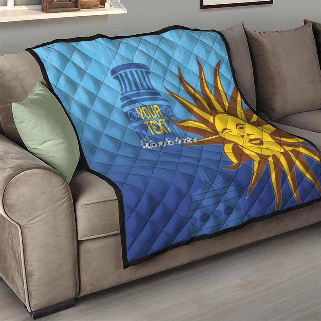 Blue quilt with custom text and golden sun face graphic on living room sofa