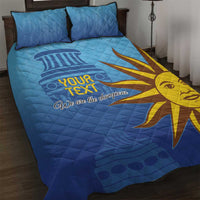 Blue quilt bed set with two pillows, yellow sun design and 'We are the champions' text