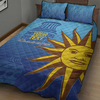 Blue quilt bed set with two pillows, large yellow sun face and 'We are the champions'