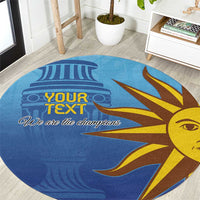 Blue round football carpet with sun-face graphic and “We are the champions” text