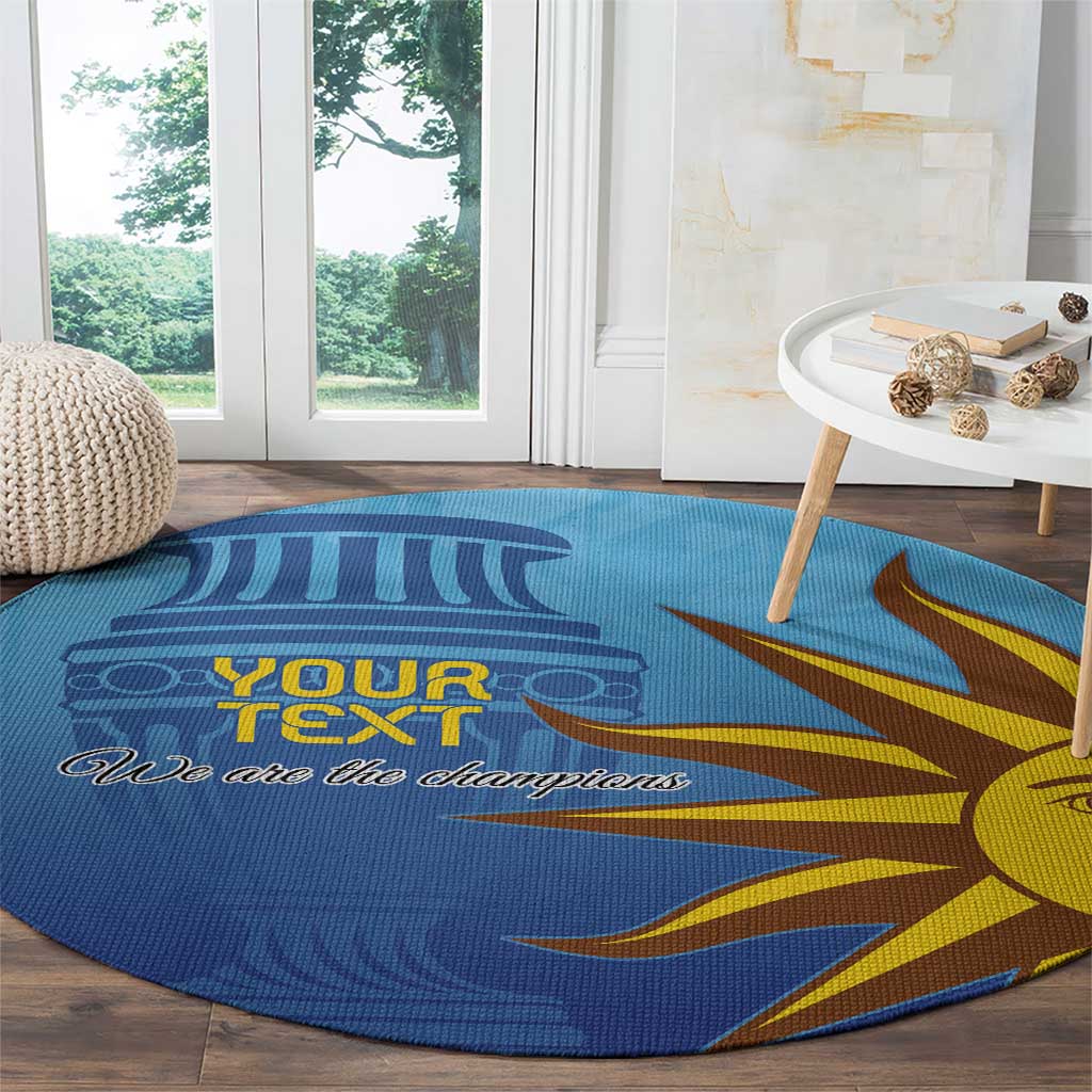 Blue round football carpet with sun-face graphic and “We are the champions”