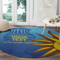 Blue round football carpet with sun-face graphic and “We are the champions”