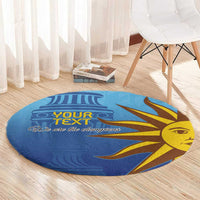 Blue round football carpet with sun-face design and “We are the champions” text