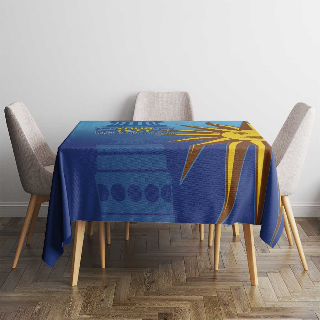 Blue tablecloth featuring yellow sun face design across the tabletop