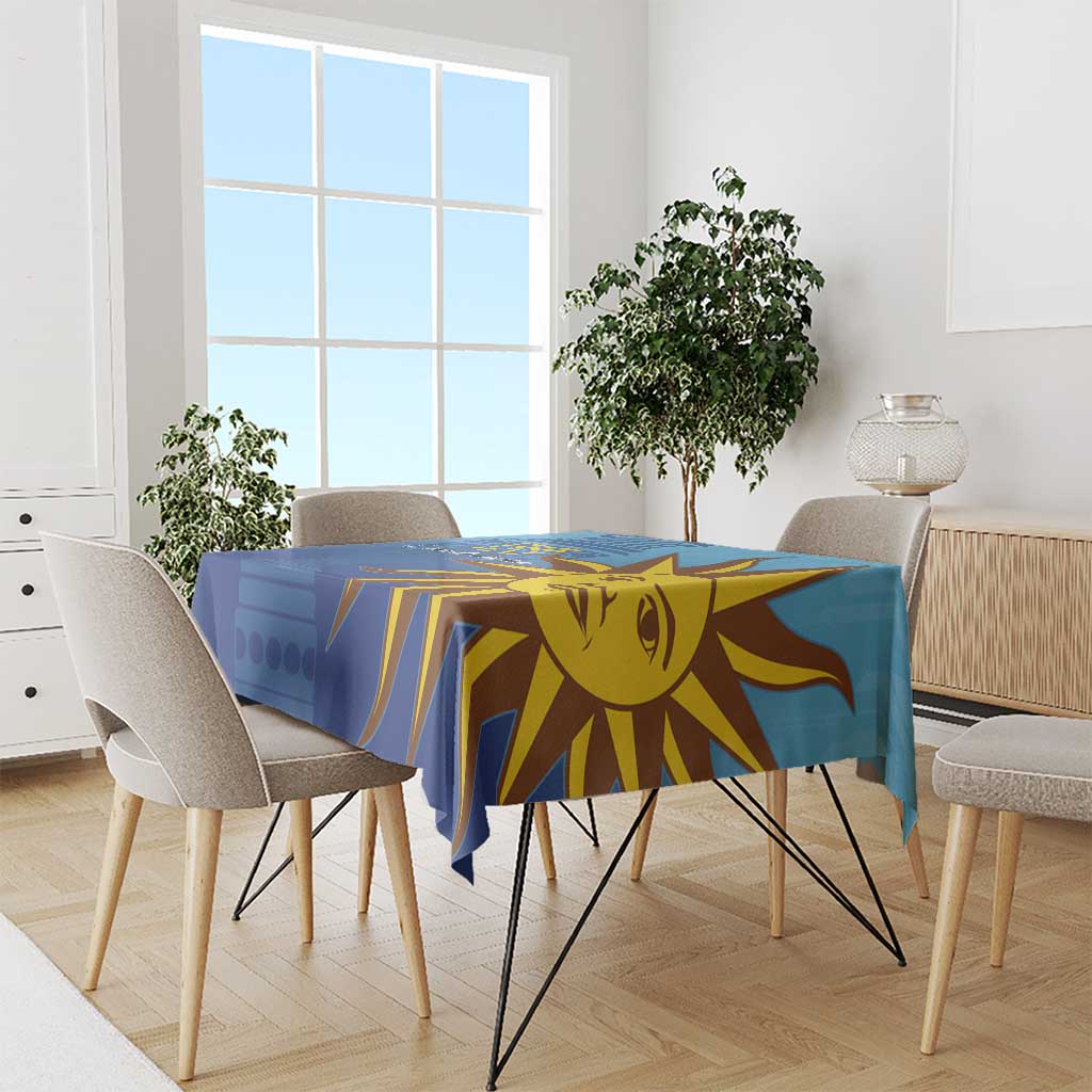 Blue football tablecloth with yellow sun face and striped rays on dining table