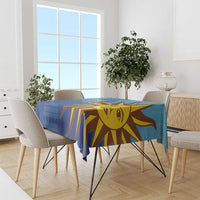 Blue football tablecloth with yellow sun face and striped rays on dining table