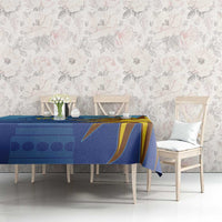 Blue tablecloth with yellow sun face graphic on rectangular dining table