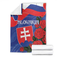 Slovakia flag blanket with rose print and folded stack, banner-style over surface