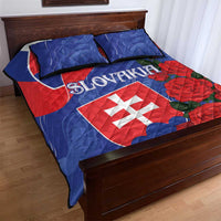 Blue and red Slovakia quilt with rose design and flag shield, two pillows on bed