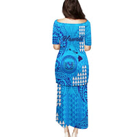 Blue long dress back view with Polynesian tribal pattern and short sleeves.