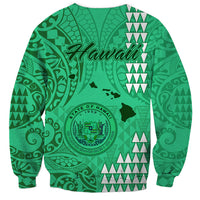 Green sweatshirt with Hawaii graphic, island silhouette, circular seal, tribal pattern, back view