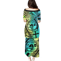 Black long off-shoulder dress with teal and yellow Polynesian print, midi length