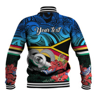 Blue tropical baseball jacket back view with ribbed collar, bold Polynesian pattern and large logo