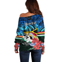 Women’s off-shoulder sweater, back view with Polynesian print and red floral details