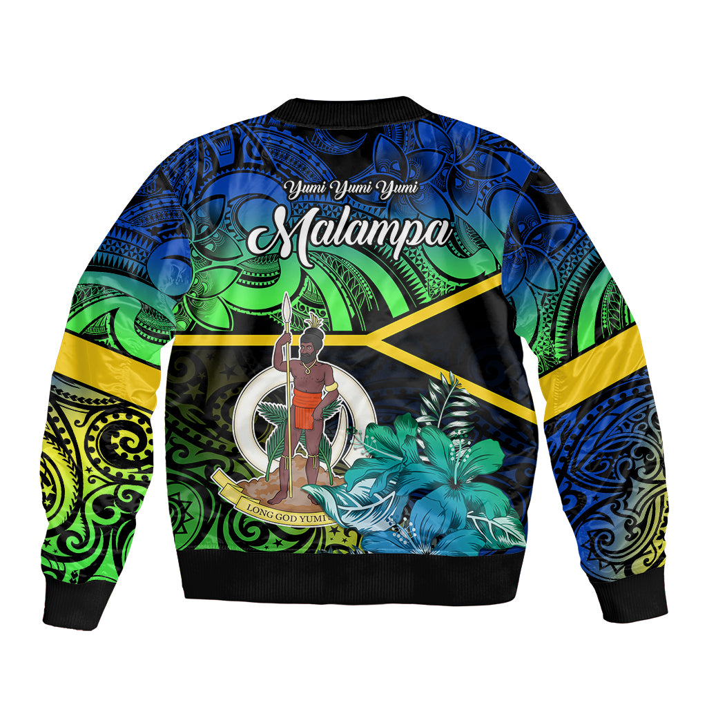 Unisex Malampa bomber jacket on black, blue-green tribal floral print with emblem circle.