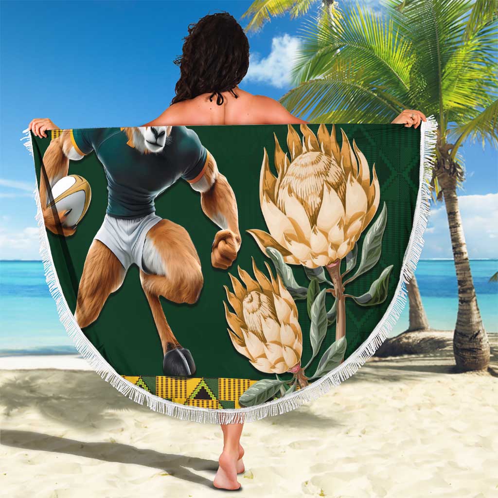 Green round beach blanket with fringe, antelope rugby player print and gold protea flowers