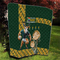 Folded green quilt with rugby world champions emblem, yellow border, Springbok and protea