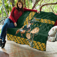 Green quilt blanket laid on outdoor sofa, yellow rugby champions emblem and Springbok graphic
