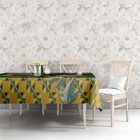 Green tablecloth with yellow geometric pattern on a dining table