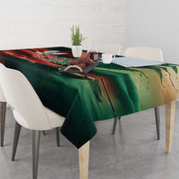 Green tablecloth with flag-themed print and graphic details on a dining table