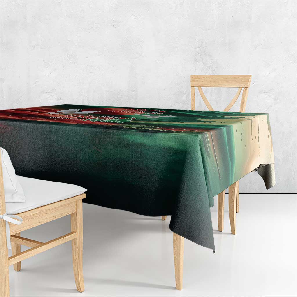 Green tablecloth with flag-themed print draped over a rectangular wooden table
