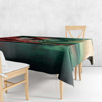 Green tablecloth with flag-themed print draped over a rectangular wooden table
