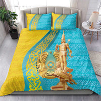 Gold and teal duvet set with two pillows featuring gold statue and ornamental borders