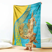 Gold, teal, and blue throw blanket with golden warrior statue graphic, corner view