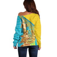 Women’s off-shoulder sweater with back view, gold yellow and blue ornate gold graphic