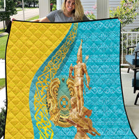 Gold and blue quilt with ornate gold statue print, framed by dark border.