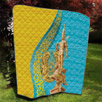 Gold and blue quilt blanket with gold statue artwork, diamond stitching texture.
