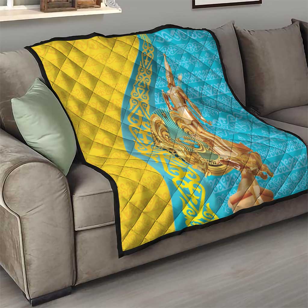 Gold and blue quilt draped over a sofa, with gold statue artwork on the center.