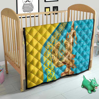 Gold and blue quilt on a toddler bed, with gold statue print and dark trim.