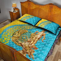 Teal and gold quilt bed set with rider silhouette medallion and two pillows with dark trim