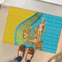Gold and teal rubber doormat with central warrior illustration and decorative patterns