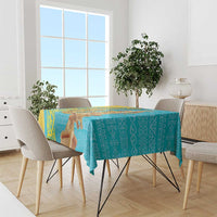 Turquoise tablecloth with gold corner patterns over dining table