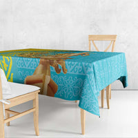 Turquoise and gold tablecloth draped over wooden table
