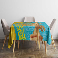 Turquoise tablecloth with gold border and horseman motif on dining table