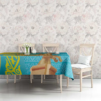 Turquoise tablecloth with gold pattern and horseman motif on dining table