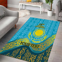 Teal-blue area rug with ornate gold motifs, sun emblem, and “YOUR TEXT” personalization