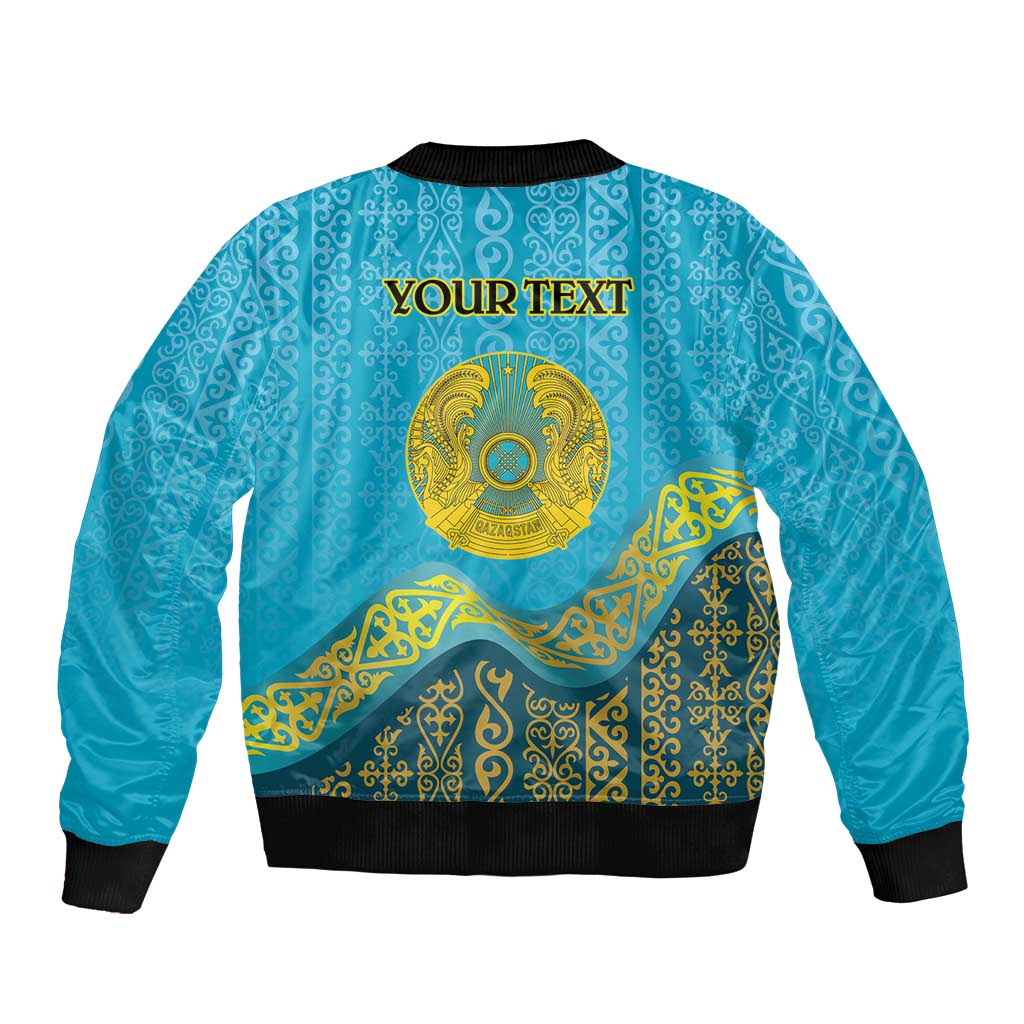 Blue bomber jacket with ornate Kazakh pattern and golden emblem; 'YOUR TEXT' on back
