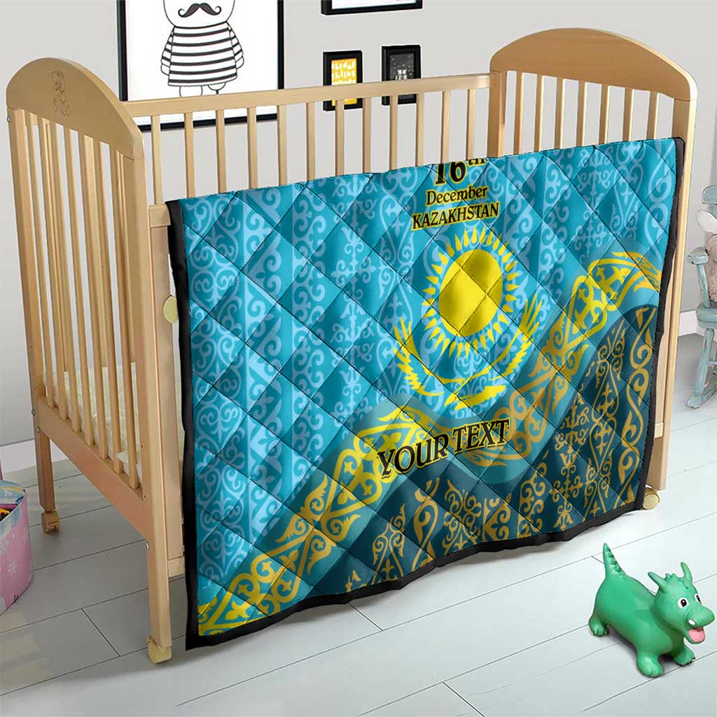 Blue quilt for crib with yellow emblem, “16th December Kazakhstan,” and “YOUR TEXT”