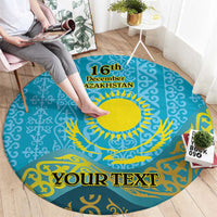 Round blue patterned carpet with yellow sunburst, '16th December Kazakhstan' and 'Your Text'