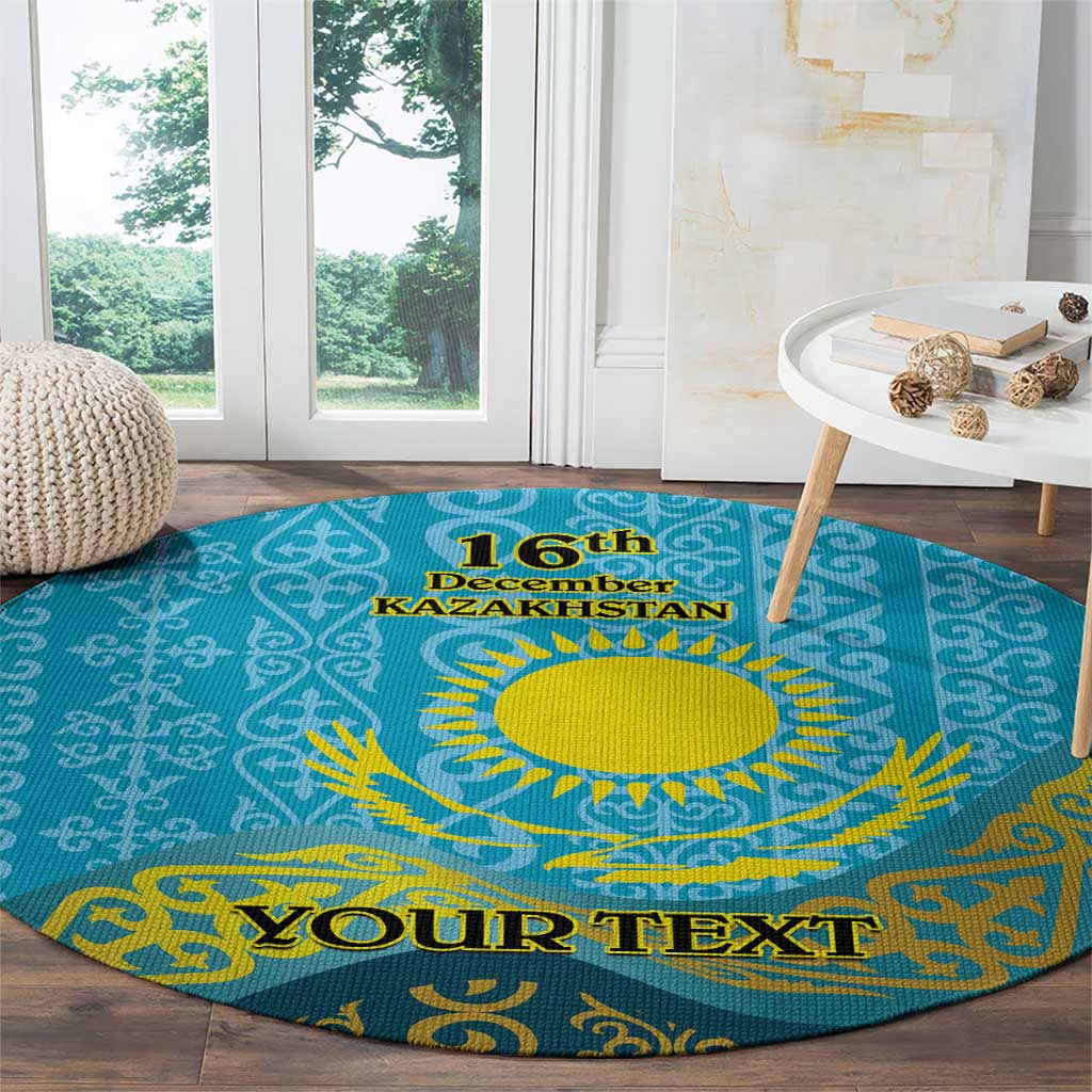 Round blue patterned carpet featuring yellow sun, '16th December Kazakhstan' and 'Your Text'