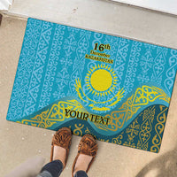 Blue rubber doormat outdoors with Kazakh pattern, '16th December Kazakhstan' and YourText