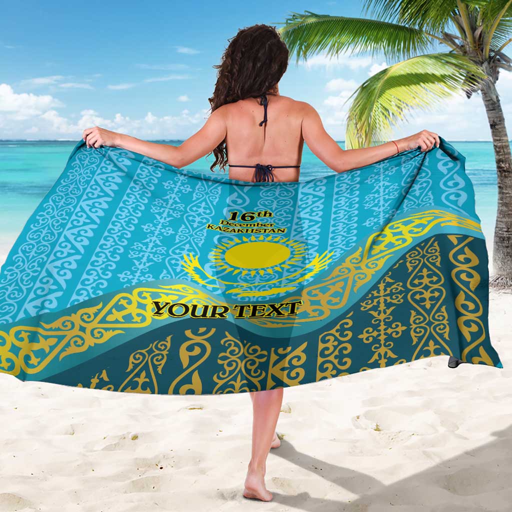 Personalized blue sarong with Kazakh pattern, circular emblem and 'YOUR TEXT' on back
