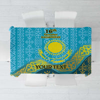 Blue tablecloth with gold Kazakh pattern, sun emblem, and 16 December banner