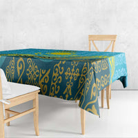 Blue tablecloth with repeating gold ornament pattern hanging over table edge