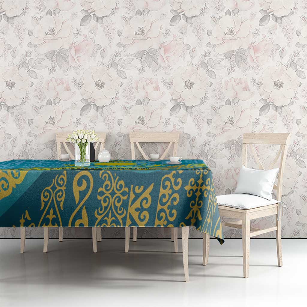 Blue and teal patterned tablecloth with gold swirls covering long dining table